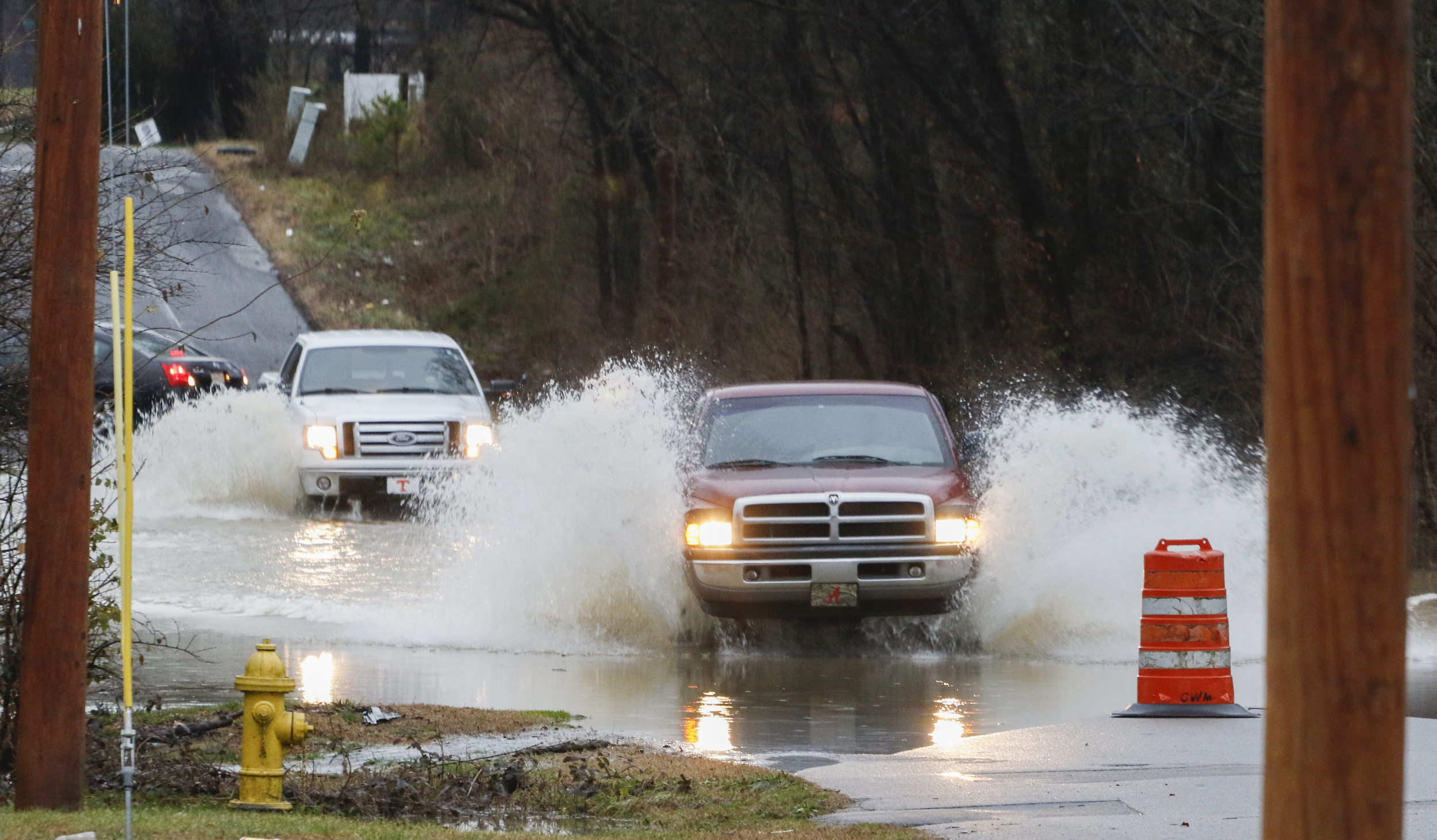 Staff Photo by Dan Henry / The Chattanooga Times Free Press- 2/3/16. Motorists make their way through standing water covering Appling Street on Wednesday, February 3, 2016, after overnight rains flooded the area.