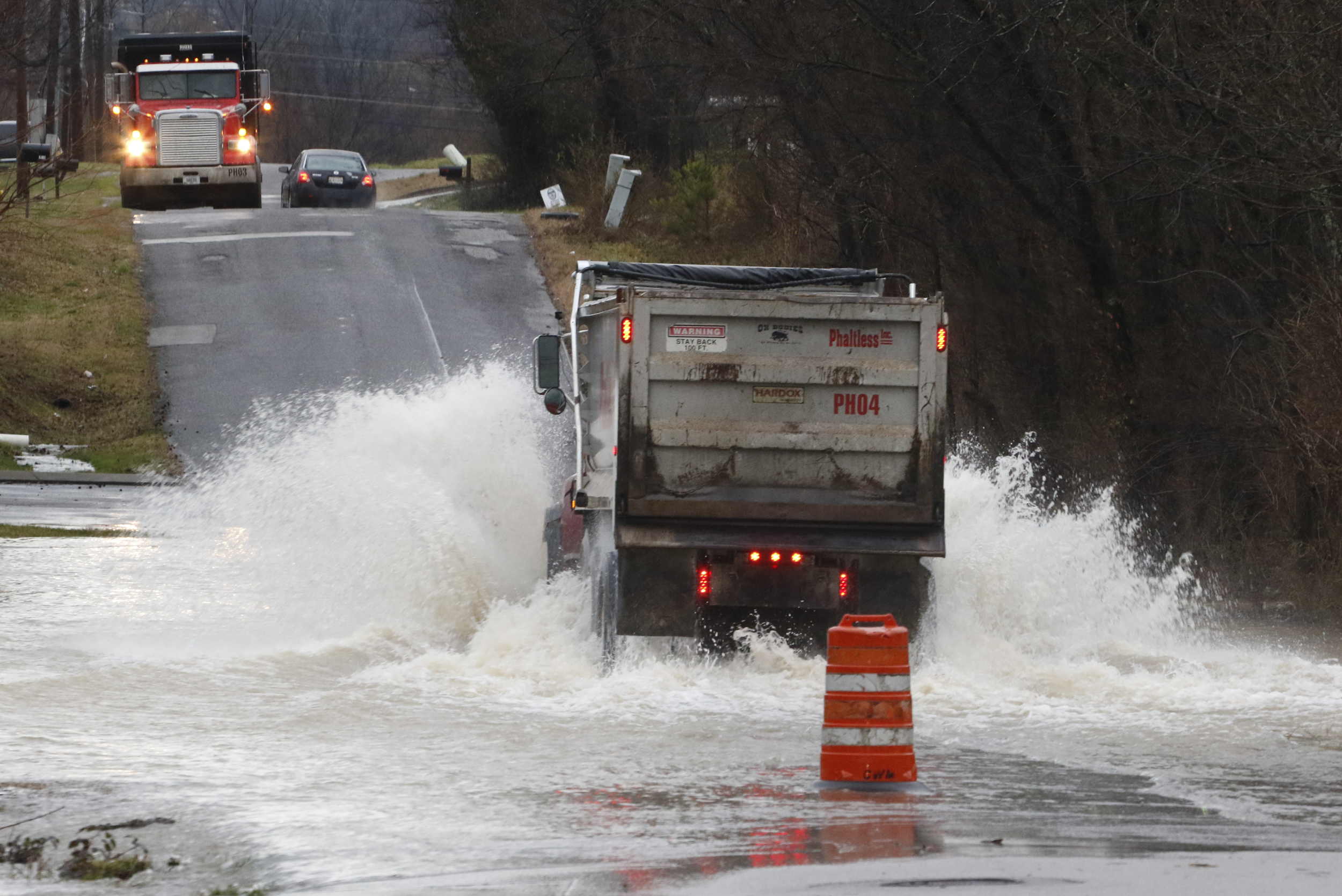 Staff Photo by Dan Henry / The Chattanooga Times Free Press- 2/3/16. Motorists make their way through standing water covering Appling Street on Wednesday, February 3, 2016, after overnight rains flooded the area.