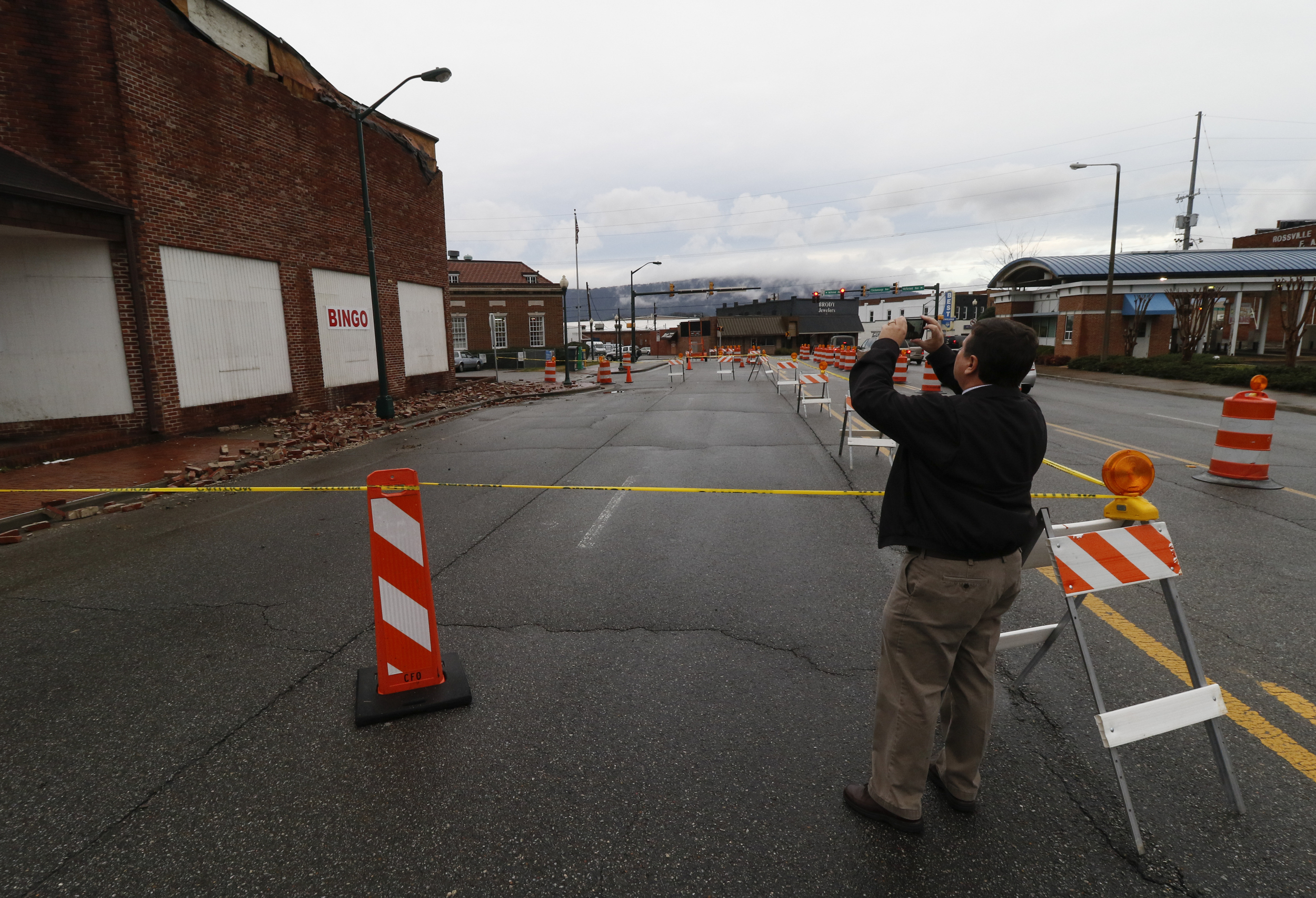 Staff Photo by Dan Henry / The Chattanooga Times Free Press- 2/3/16. Rossville Mayor Teddy Harris takes photos on Wednesday, February 3, 2016, after overnight rains brought down a part of the Bingo hall's wall in Rossville, Ga.