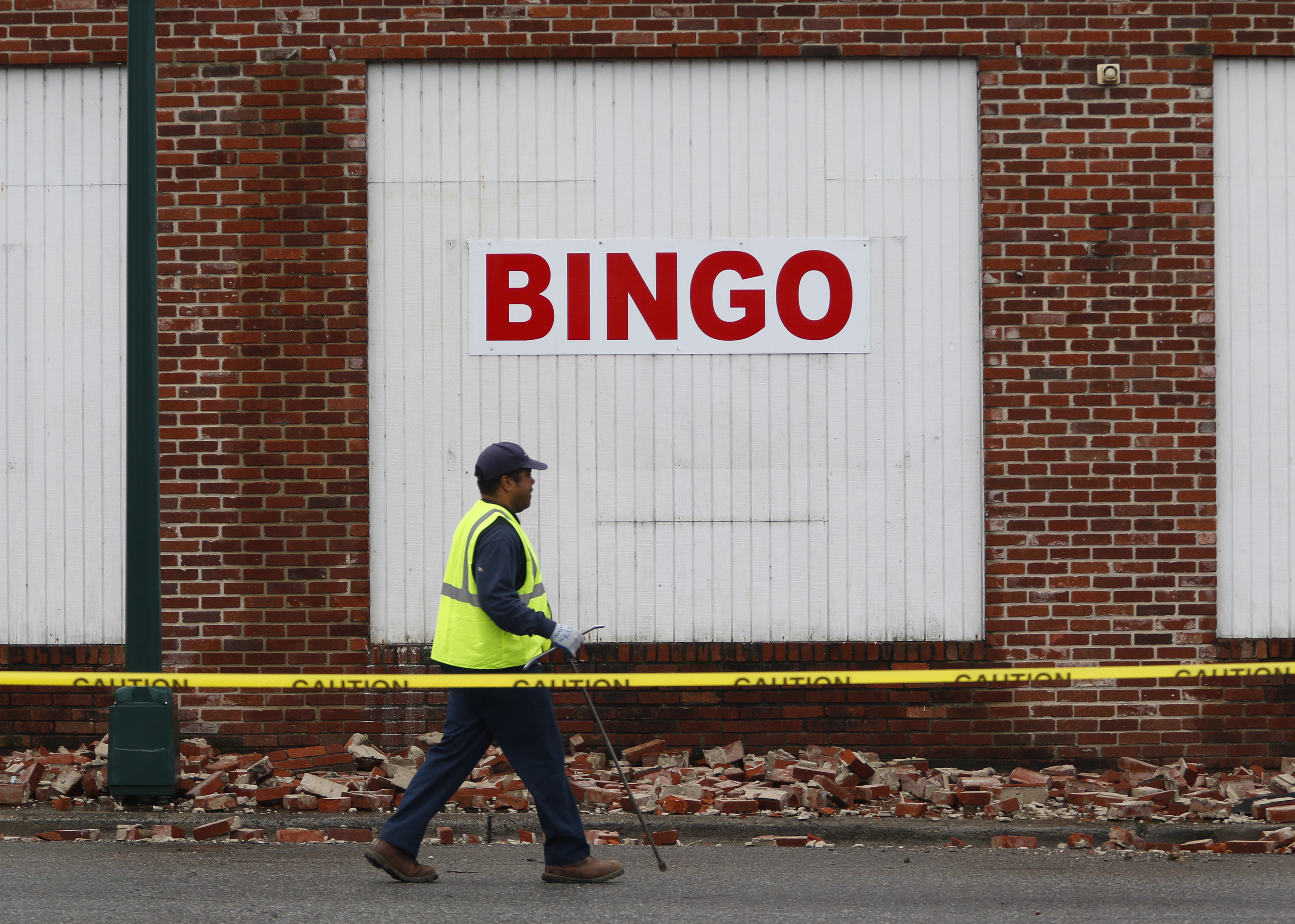 Staff Photo by Dan Henry / The Chattanooga Times Free Press- 2/3/16. Tennesee American Water employee John Boyer prepares to turn off a water line on Wednesday, February 3, 2016, after overnight rains brought down a part of the Bingo hall's wall in Rossville, Ga.