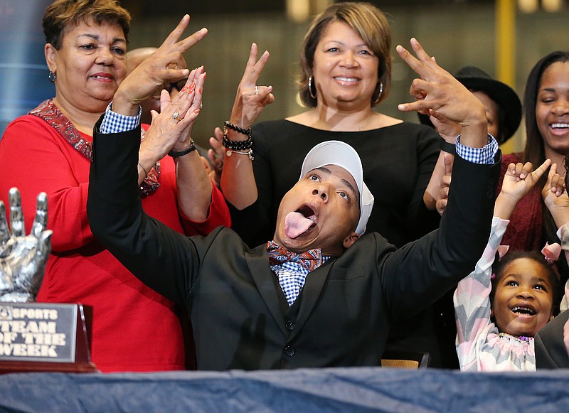 Nigel Warrior, a safety from Peachtree Ridge High School who is headed to the University of Tennessee, celebrates during his signing day ceremony Wednesday at the College Football Hall of Fame in Atlanta. Warrior was among four crucial late additions to the Volunteers' 2016 class, which was ranked in the top 15 by at least two national recruiting services.
