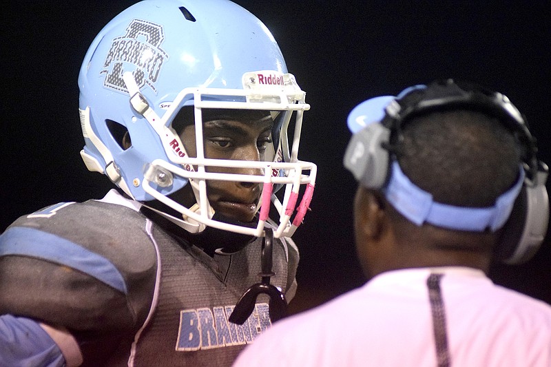 Brainerd quarterback Malik Beavers (1) confers with head coach Brian Gwyn.  The Bledsoe County Warriors visited the Brainerd Panthers in TSSAA football action Friday night, October 23, 2015.