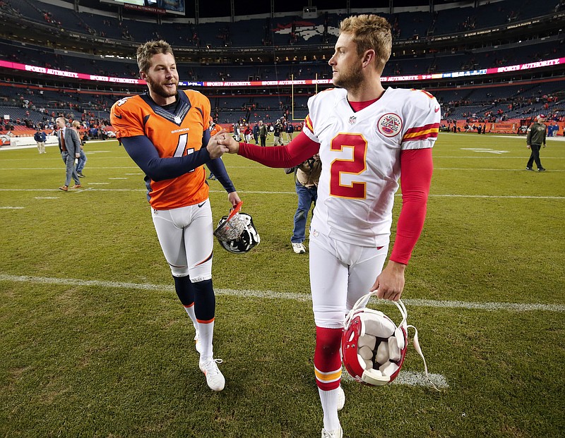 
              FILE - In this Nov. 15, 2015, file photo, Denver Broncos punter Britton Colquitt, left, shakes hands with his brother Kansas City Chiefs punter Dustin Colquitt following an NFL football game in Denver. Like his father, Britton has a chance to win his own ring Sunday when his Broncos face the Carolina Panthers in Super Bowl 50. Their dad Craig Colquitt won two Super Bowls with the Pittsburgh Steelers. (AP Photo/Jack Dempsey, File)
            