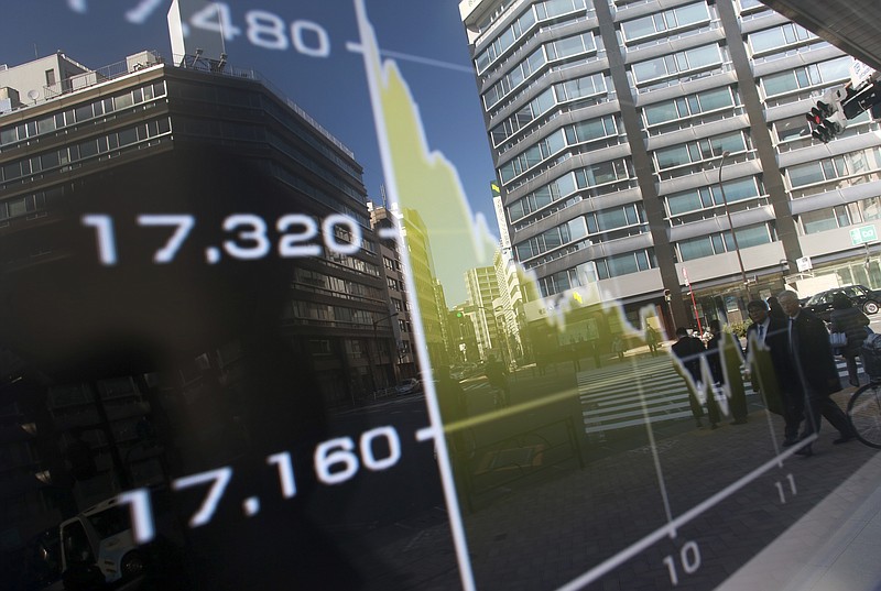 
              Pedestrians are reflected on an electronic stock board showing Japan's Nikkei 225 chart at a securities firm in Tokyo, Wednesday, Feb. 3, 2016. Asian shares stumbled Wednesday as another steep drop in the price of oil reinforced worries about the potential impact on the world economy of job cuts and reduced investment in the energy industry. (AP Photo/Eugene Hoshiko)
            