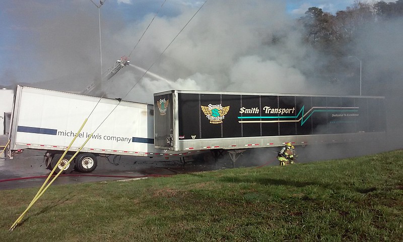 Firefighters work to put out a tractor trailer fire Wednesday behind Fire Station 17 in a parking lot near B&B Discount Sales on Signal Mountain Road.