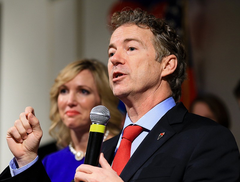 In this Feb. 1, 2016 file photo, Sen. Rand Paul, R-Ky, speaks to supporters with his wife Kelley by his side, during a caucus night victory party at the Scottish Rite Consistory in Des Moines, Iowa. Paul is dropping out of the 2016 race for president. A campaign spokeswoman confirmed his decision Wednesday, Feb. 3, 2016, to The Associated Press, saying a statement would be forthcoming. (AP Photo/Nati Harnik, File)