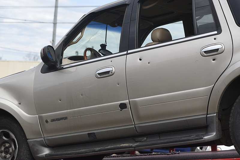 At least nine bullets were fired into this gold Lincoln Navigator that swerved into oncoming traffic causing a multvehicle accident in the 5300 block of Brainerd Road on Wednesday.