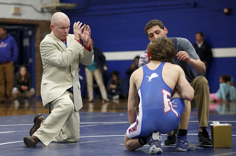 Red Bank wrestling coach Shane Turner, left, talks with Lions wrestler Gage Evans during a match last month. Red Bank faces Notre Dame in the first round of the Class A/AA state duals, which start today.