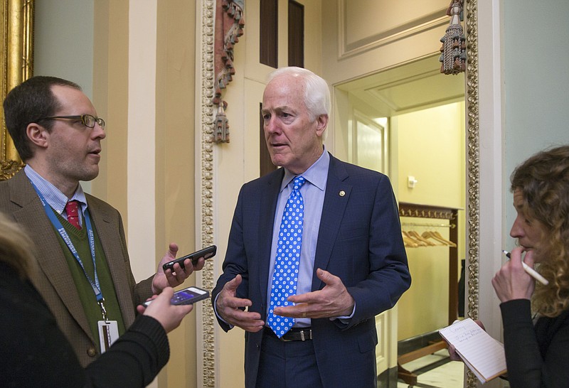 
              Senate Majority Whip John Cornyn of Texas, talks to reporters on Capitol Hill in Washington, Wednesday, Feb. 3, 2016, as he walks to a closed-door meeting with fellow Republicans during work on the energy reform bill. Democrats want to attach a federal aid package to the bipartisan energy bill to help the Flint, Mich., health crises caused by corroded lead pipes.   (AP Photo/J. Scott Applewhite)
            