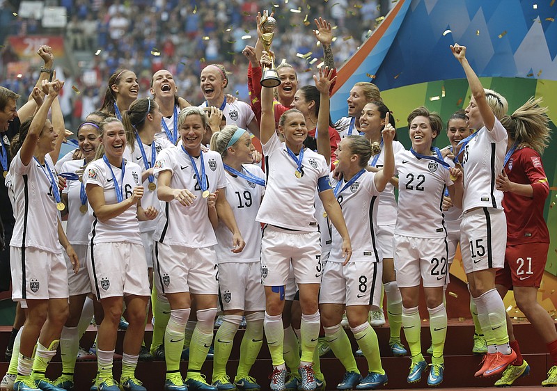 
              FILE - In this Sunday, July 5, 2015 file photo, the United States Women's National Team celebrates with the trophy after they beat Japan 5-2 in the FIFA Women's World Cup soccer championship in Vancouver, British Columbia, Canada. The U.S. Soccer Federation’s original lawsuit against the union for its champion women’s national team has been sealed after the governing body realized it had disclosed the home addresses and email accounts of many players, Thursday, Feb. 4, 2016.(AP Photo/Elaine Thompson, File)
            