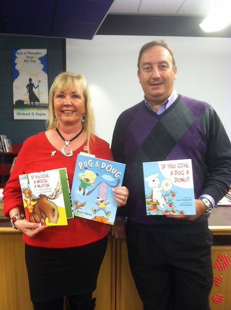 Donna Horn, Hamilton Place Rotary Club member, delivers 25 books to Dr. Bryan Stewart, principal of East Brainerd Elementary School.