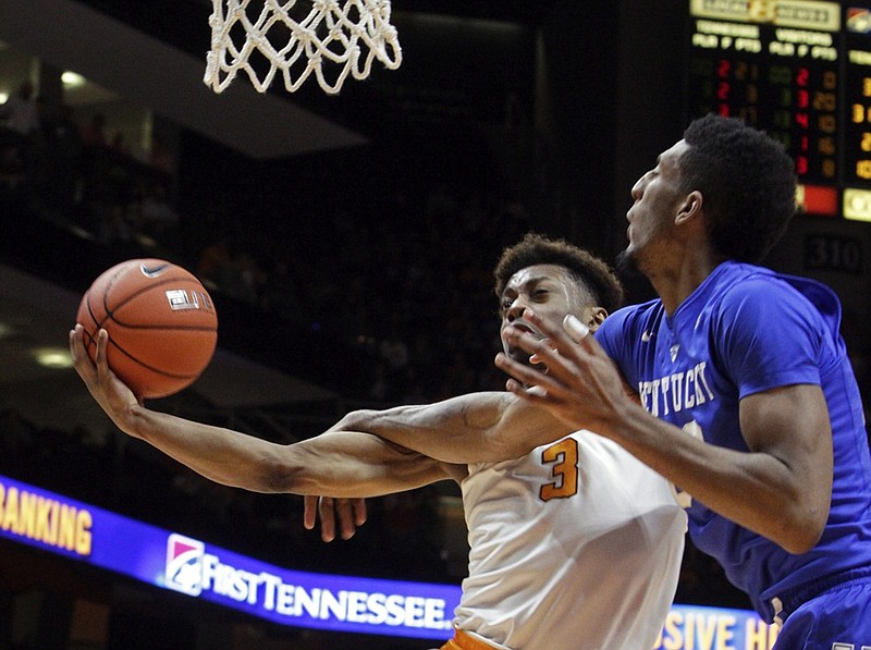 Tennessee guard Robert Hubbs III, with ball, is fouled by Kentucky forward Alex Poythress during Tuesday's game in Knoxville, which the Vols won 84-77 after trailing by 21 points.