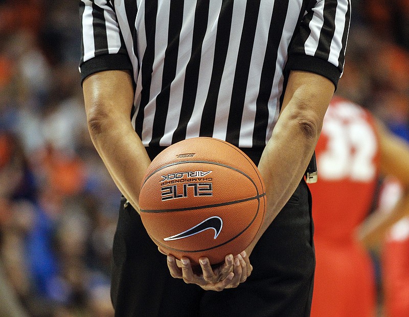 
              FILE - In this Jan. 3, 2016, file photo, an official holds the ball behind his back during a break in the second half of an NCAA college basketball game between New Mexico and Boise State in Boise, Idaho. Referees undergo nearly as much scrutiny as the teams that want to join in March Madness, with a field of nearly 1,000 that is winnowed to 100 for tournament time. And just like the teams, the refs have to be on their game to keep advancing. (AP Photo/Otto Kitsinger, File)
            