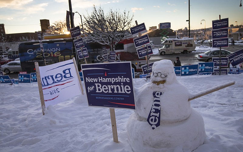 
              A snowman built by supporters of Democratic presidential candidate Sen. Bernie Sanders, I-Vt., stands outside the Verizon Wireless Center, Friday, Feb. 5, 2016, in Manchester, N.H. (AP Photo/John Minchillo)
            