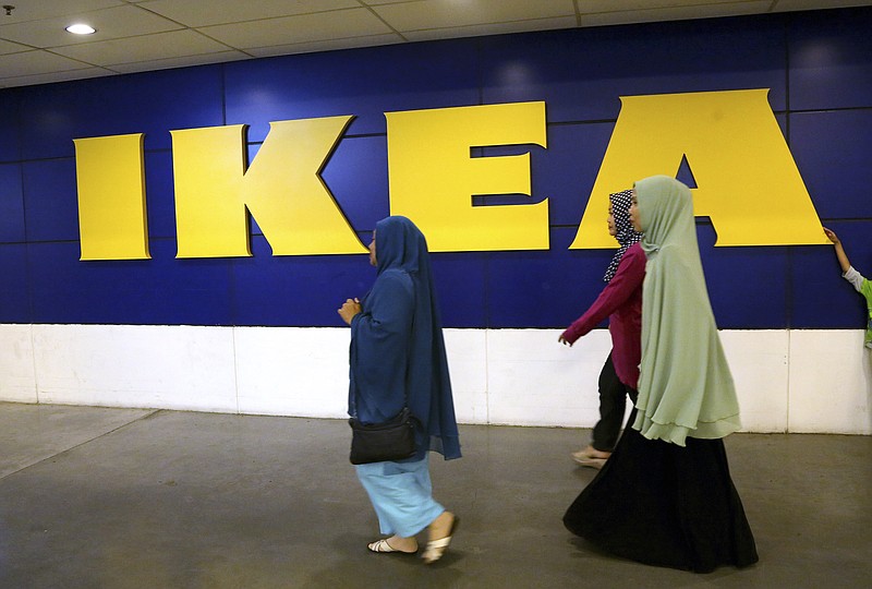 
              Muslim women walk by a sign at the IKEA store in Tangerang, Indonesia, Friday, Feb. 5, 2016. The furniture giant, founded in Sweden in 1943, has lost a trademark dispute in Indonesia after the country's highest court agreed the IKEA name was owned by a local company. Indonesian rattan furniture company PT Ratania Khatulistiwa registered its IKEA trademark on Dec. 2013. It's an acronym of the Indonesian words Intan Khatulistiwa Esa Abadi, which refer to the rattan industry. (AP Photo/Tatan Syuflana)
            