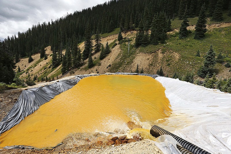 
              File--In this Wednesday, Aug. 12, 2015, file photograph, water flows through a series of retention ponds after a spill at the Gold King mine near Silverton, Colo. On Friday, Feb. 5, 2016, the Environmental Protection Agency said that the three million gallon spill from the gold mine may have dumped more than 880,000 pounds of metals into the Animas River. (AP Photo/Brennan Linsley, file)
            