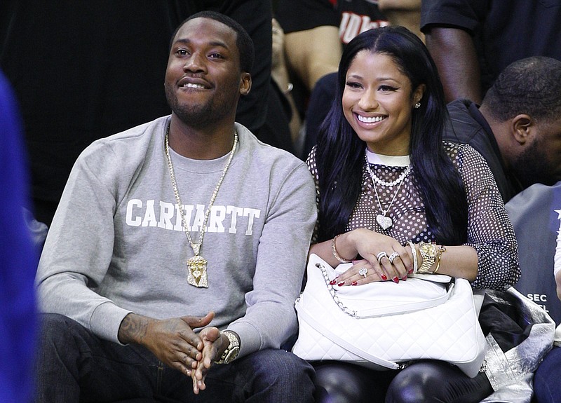
              FILE - In this Jan. 16, 2016 file photo, Nicki Minaj, right, and Meek Mill, left, watch action from the sidelines during the first half of an NBA basketball game between the Portland Trail Blazers and the Philadelphia 76ers, in Philadelphia. Mill must serve three months of house arrest for parole violations that he blames on his erratic concert schedule but Philadelphia prosecutors link to his romance with Minaj. Common Pleas Judge Genece Brinkley also ordered him to spend six more years on probation.(AP Photo/Chris Szagola, File)
            