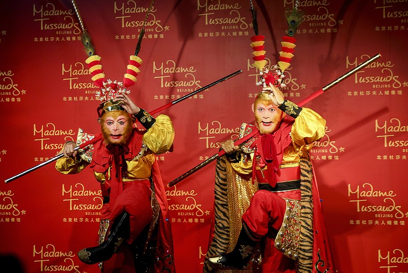 
              In this April 29, 2015 photo, actor Zhang Jinlai in a Monkey King costume poses next to a wax figure base on his stage performance during a ceremony at the Madame Tussauds in Beijing. The Year of the Monkey gives a little-needed excuse to reference the much loved Monkey King character from the 16th century adventure novel “Journey to the West.” The supernatural Monkey King, also known as Sun Wukong, accompanied a monk on a journey to retrieve sacred scriptures and the story has inspired countless TV shows and movies over the years. Unashamedly trying to capitalize on the new zodiac year, yet another Monkey King adaptation will be released on the first day of the lunar new year - Feb. 8. (Chinatopix via AP) CHINA OUT
            