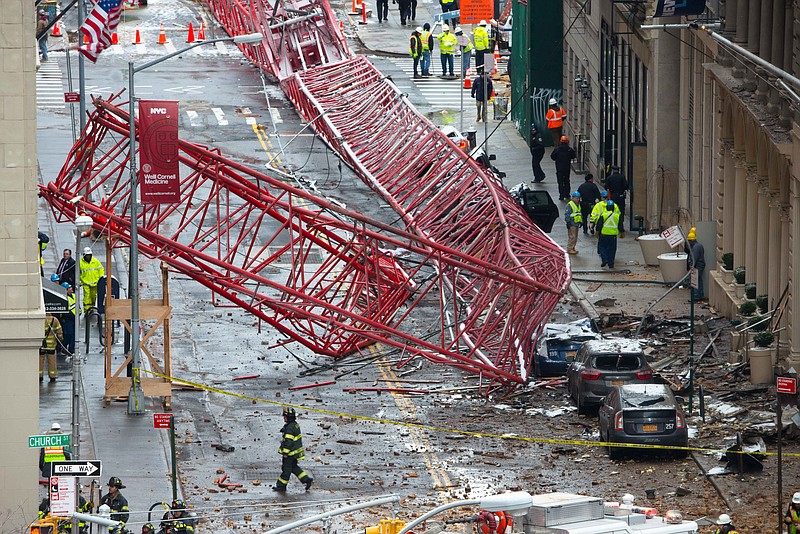 
              A collapsed crane fills the street on Friday, Feb. 5, 2016, in New York. The huge construction crane was being lowered to safety in a snow squall when plummeted onto the street in the Tribeca neighborhood of lower Manhattan.  (Brian Marrone via AP)
            