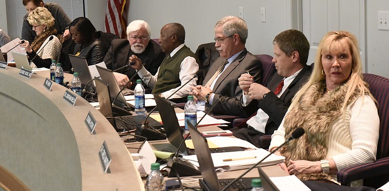 Former Hamilton County School Superintendent Rick Smith, third from right, waits with school board members for their meeting to start on Thursday, Jan. 21, 2016, in Chattanooga, Tenn. Seated from left are Rhonda Thurman, Karitsa Mosley, David Testerman, George Ricks, Sr., Smith, Dr. Jonathan Welch and Donna Horn. 
