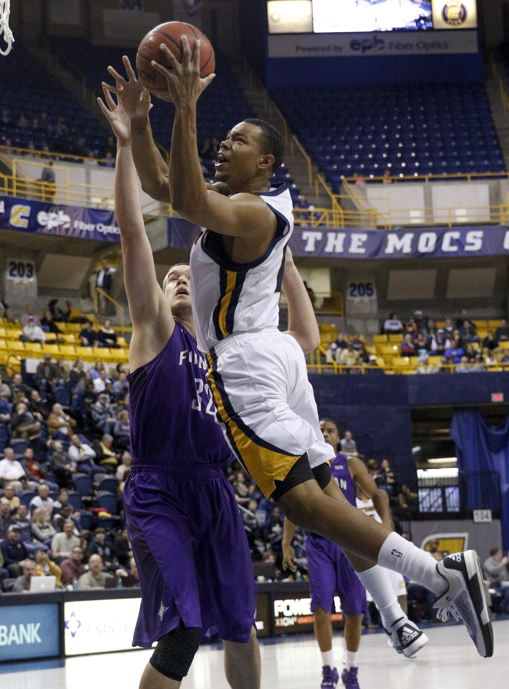 UTC forward Chuck Ester shoots over Furman forward Matt Rafferty during the Mocs' home basketball game against the Paladins at McKenzie Arena on Saturday, Feb. 6, 2016, in Chattanooga, Tenn.