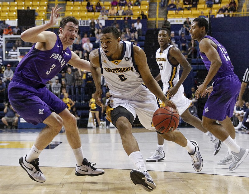 UTC forward Chuck Ester breaks around Furman forward Geoff Beans during the Mocs' home basketball game against the Paladins at McKenzie Arena on Saturday, Feb. 6, 2016, in Chattanooga, Tenn.