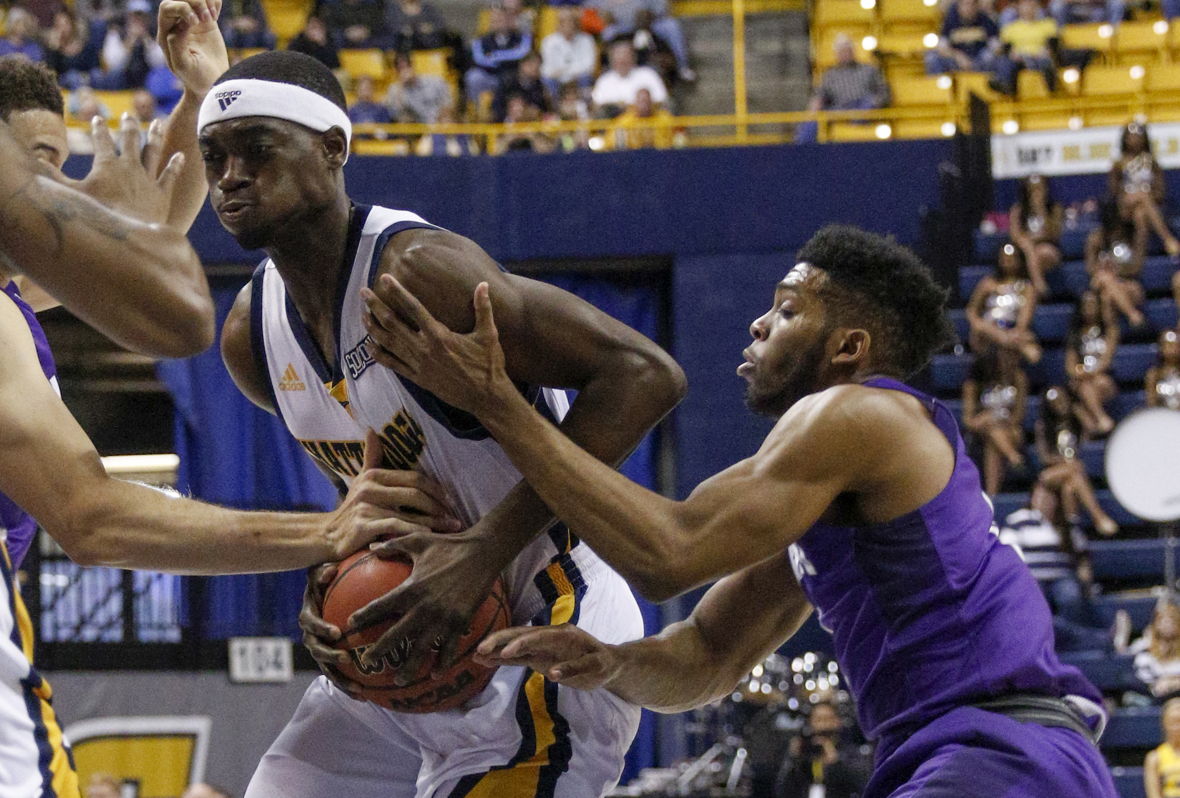 UTC guard Dee Holdham protects the ball from Furman guard Devin Sibley during the Mocs' home basketball game against the Paladins at McKenzie Arena on Saturday, Feb. 6, 2016, in Chattanooga, Tenn.