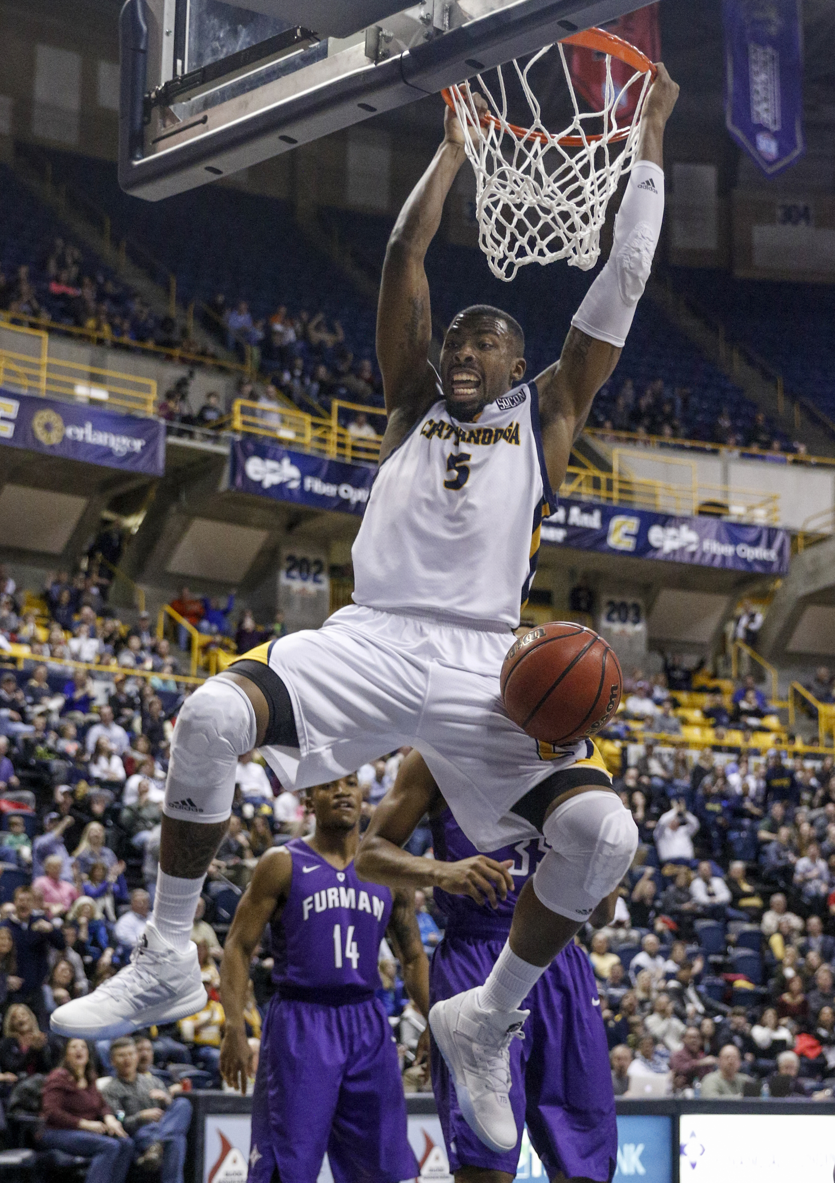 UTC forward Justin Tuoyo dunks the ball during the Mocs' home basketball game against the Furman Paladins at McKenzie Arena on Saturday, Feb. 6, 2016, in Chattanooga, Tenn.