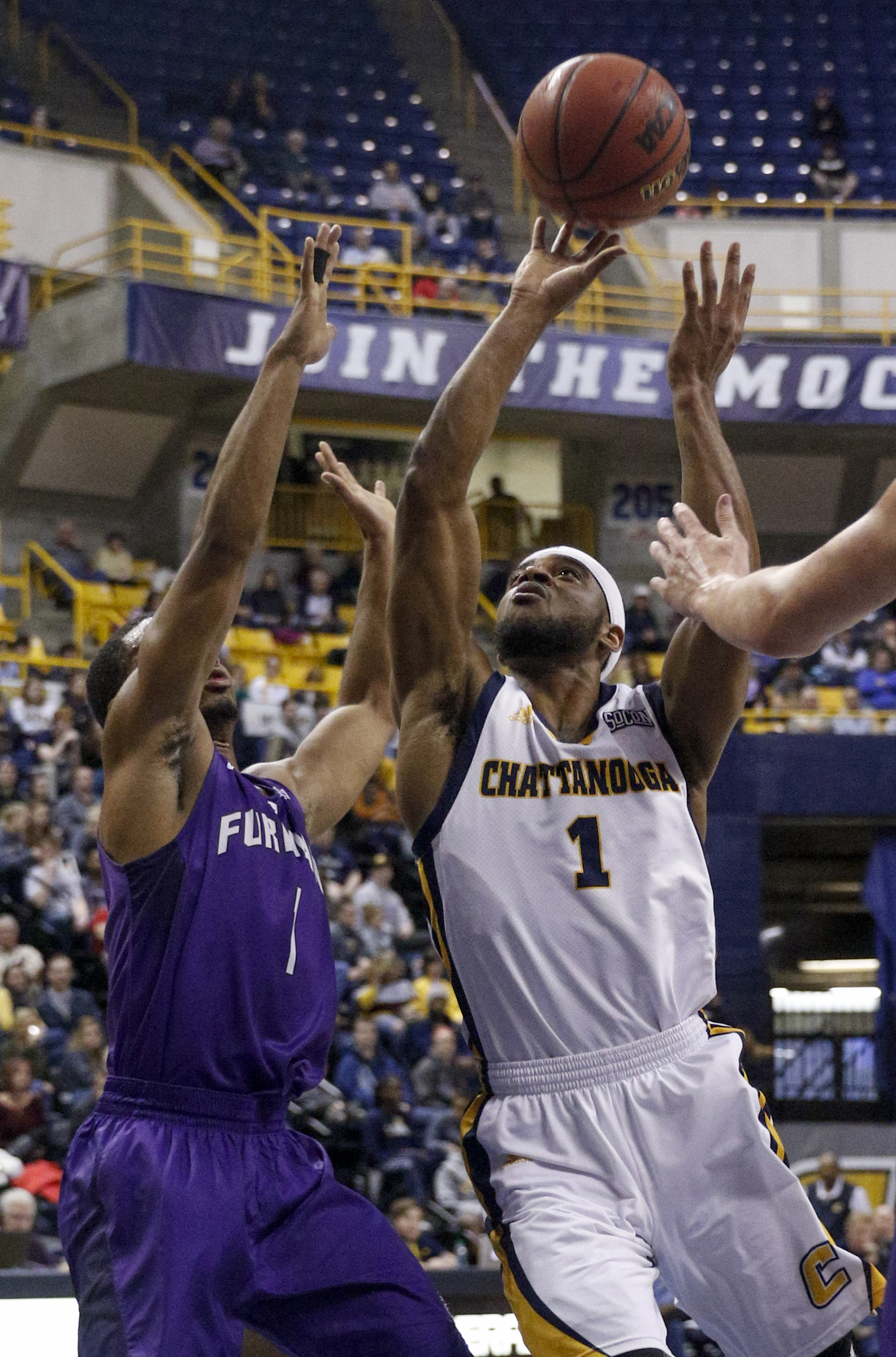 UTC guard Greg Pryor shoots into firman guard John Davis III during the Mocs' home basketball game against the Paladins at McKenzie Arena on Saturday, Feb. 6, 2016, in Chattanooga, Tenn.