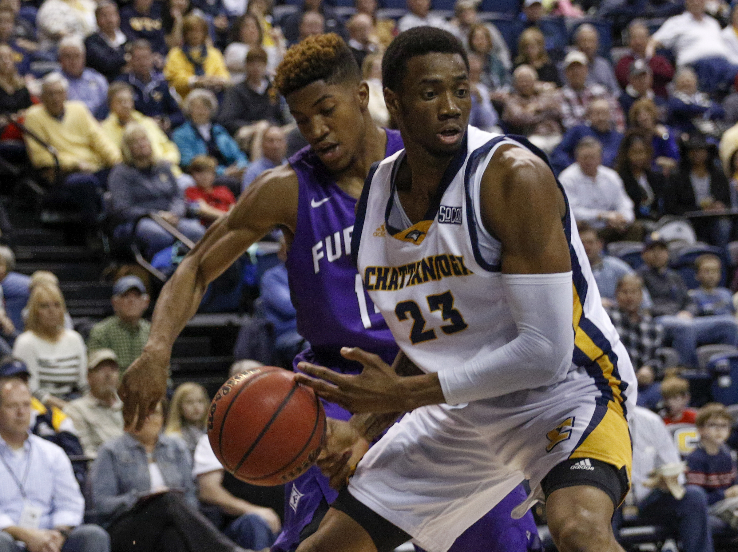 Furman guard Stephen Croone, left, knocks the ball free from the hands of UTC forward Tre' McLean during the Mocs' home basketball game against the Paladins at McKenzie Arena on Saturday, Feb. 6, 2016, in Chattanooga, Tenn.