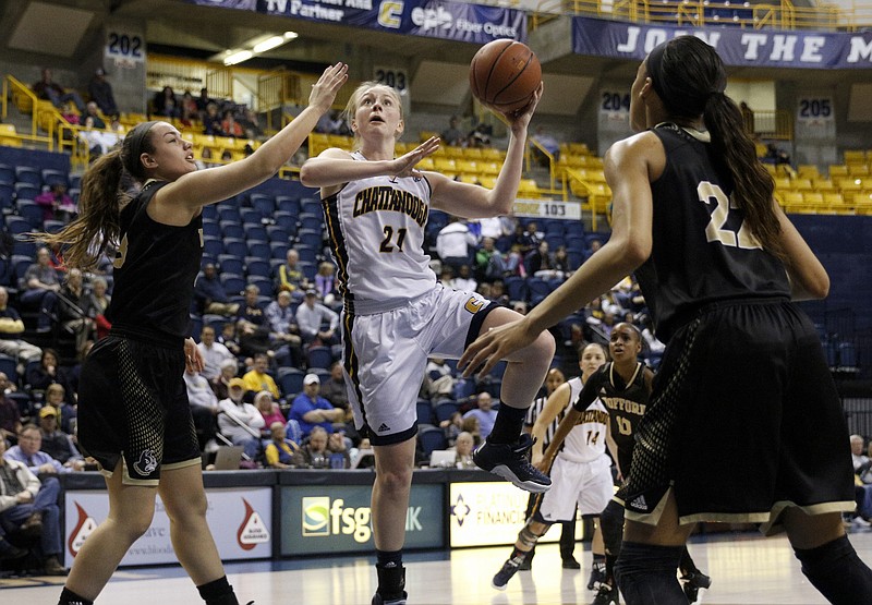 UTC forward Sydney Vanlandingham (21) shoots between Wofford's Kelsey Lambdin, left, and Kentra Washington during the Mocs' home basketball game against the Terriers at McKenzie Arena on Saturday, Feb. 6, 2016, in Chattanooga, Tenn.