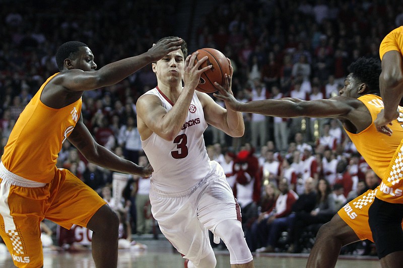 Arkansas' Dusty Hannahs (3) drives through Tennessee's defense during the first half of an NCAA college basketball game Saturday, Feb. 6, 2016, in Fayetteville, Ark. (AP Photo/Samantha Baker)