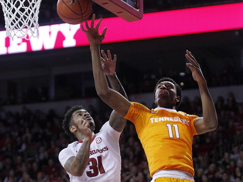 Arkansas' Anton Beard (31) cannot stop Tennessee's Kyle Alexander (11) from making a shot during the second half of an NCAA college basketball game Saturday, Feb. 6, 2016, in Fayetteville, Ark. Arkansas won 85-67. (AP Photo/Samantha Baker)
