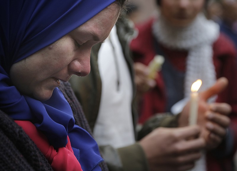 
              A mourner grieves at a candlelight vigil in memory of slain Italian graduate student Giulio Regeni, in front of the Italian embassy in Cairo, Egypt, Saturday, Feb. 6, 2016. Regeni disappeared on Jan. 25, the anniversary of Egypt's 2011 uprising. He was found this week with multiple stab wounds, cigarette burns and other signs of torture on the outskirts of Cairo, Egyptian officials said. (AP Photo/Amr Nabil)
            
