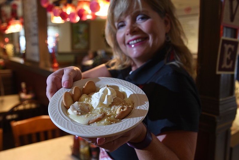 Marlene Geren holds the Countryside Cafe's famous banana pudding before serving it at the Mahan Gap Road restaurant.