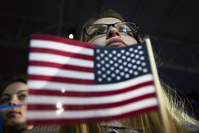 
              An audience member listens as Democratic presidential candidate Sen. Bernie Sanders, I-Vt., speaks during a campaign stop at the University of New Hampshire Whittemore Center Arena, Monday, Feb. 8, 2016, in Durham, N.H. (AP Photo/John Minchillo)
            