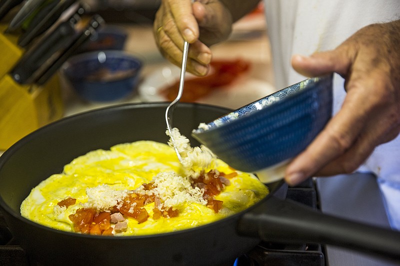 "Don't expect this to be a task where you add everything to the pan and walk away," says omelet expert Alana Zamora. "I am always using one hand to work the skillet and the other holds the spatula."