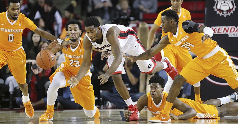 From left, Tennessee's Kevin Punter, Derek Reese, Admiral Schofield and Devon Baulkman, from left, team up to steal the ball from Georgia forward Yante Maten during last month's game in Athens.