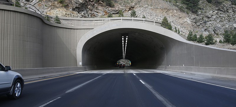 
              In this Saturday, Aug. 8, 2015, photograph taken near Idaho Springs, Colo., traffic flows through one of the newly-reconstructed twin tunnels along Interstate 70. Voter-sanctioned tax limits are threatening the state's growth, which depends on a functioning road system that has become crippled under the burden of an expanding population in recent years. (AP Photo/David Zalubowski)
            