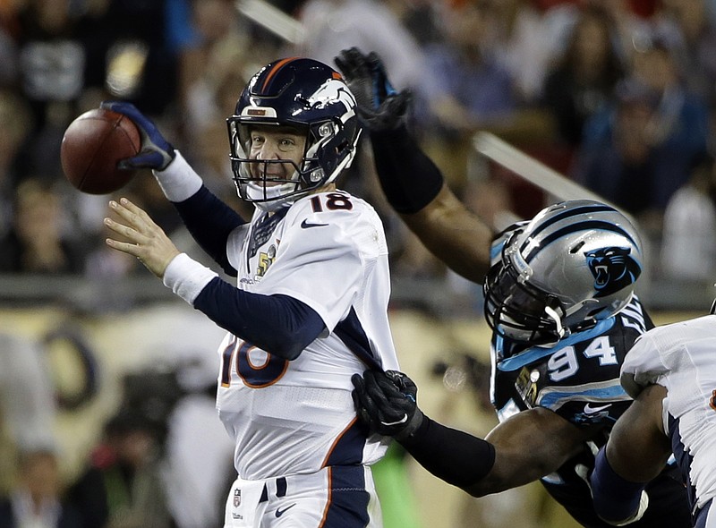 Denver Broncos' Peyton Manning (18) loses the ball as he is hit by Carolina Panthers' Kony Ealy (94) during the second half of the NFL Super Bowl 50 football game Sunday, Feb. 7, 2016, in Santa Clara, Calif. The Panthers recovered the fumble. 