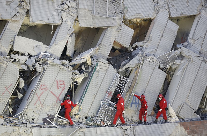 Emergency rescuers continue to search for missing in a collapsed building from an earthquake in Tainan, Taiwan, Sunday, Feb. 7, 2016.