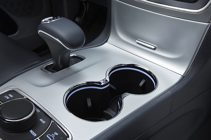 
              This photo provided by Fiat Chrysler Automobiles shows the interior of a 2014 Jeep Grand Cherokee Overland. U.S. auto safety investigators have determined that electronic gear shifters, like the one at upper left, in some newer Fiat Chrysler SUVs and cars are so confusing that drivers have exited the vehicles while they are in gear, causing 121 crashes and 30 injuries. The National Highway Traffic Safety Administration has doubled the number of vehicles in the investigation to more than 856,000. But it stopped short of calling for a recall. The probe now covers 2014 and 2015 Jeep Grand Cherokees and 2012 through 2014 Dodge Charger and Chrysler 300 sedans with 3.6-liter V6 engines. (Fiat Chrysler Automobiles via AP)
            