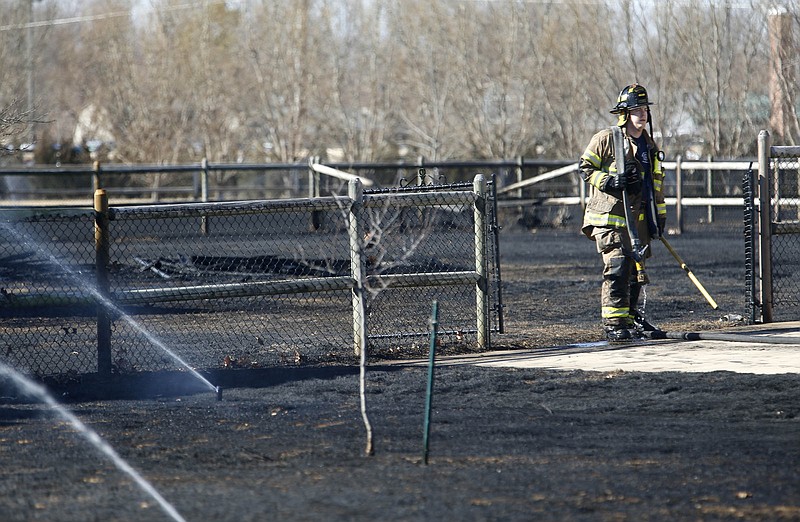 
              In this photo taken on Monday, Feb. 8, 2016, a Broken Arrow firefighter returns equipment to his fire truck after battling a grass fire in a neighborhood in Broken Arrow, Okla. The fire burned through several yards but no homes were damaged. (James Gibbar/Tulsa World via AP) ONLINE OUT; KOTV OUT; KJRH OUT; KTUL OUT; KOKI OUT; KQCW OUT; KDOR OUT; TULSA OUT; TULSA ONLINE OUT; MANDATORY CREDIT
            