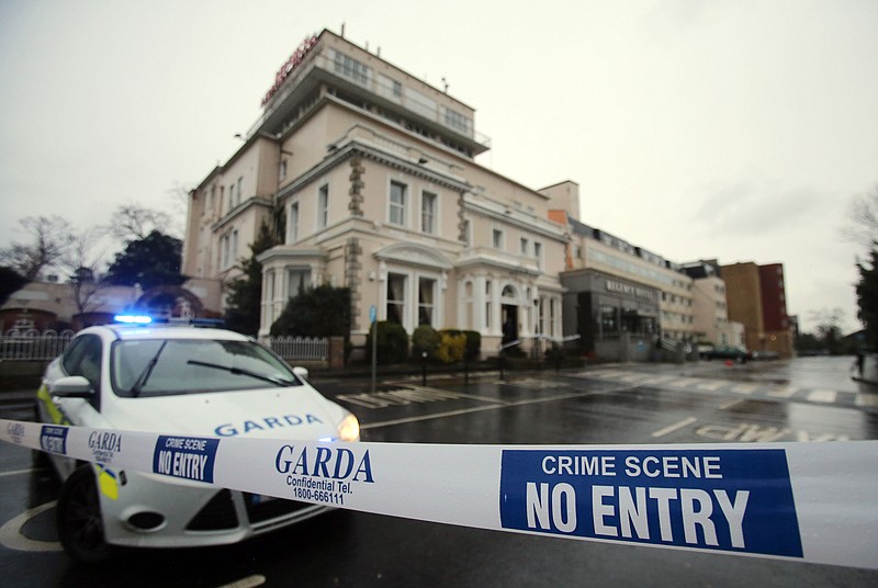 
              FILE - This is a Friday Feb. 5, 2016 file photo of a  police cordon outside the Regency Hotel in Dublin, Ireland, after one man died and two others were injured following a shooting incident at the hotel. An Irish Republican Army faction has claimed responsibility Monday Feb. 8, 2016, for killing a reputed member of a drug-dealing gang in a machine gun attack on a Dublin boxing pre-match event and is threatening to kill more criminal rivals.(Niall Carson / PA via AP) UNITED KINGDOM OUT - NO SALES - NO ARCHIVES
            