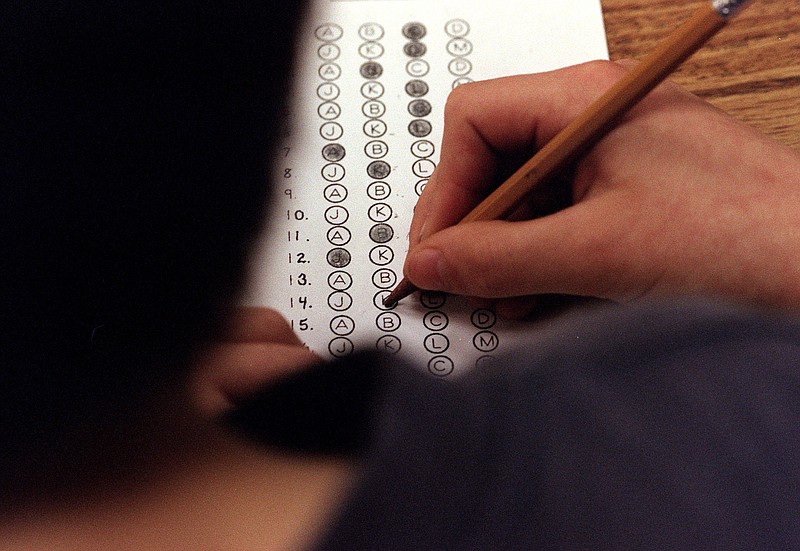 A student fills out an answer on the practice test given prior to a traditional paper standardized test.