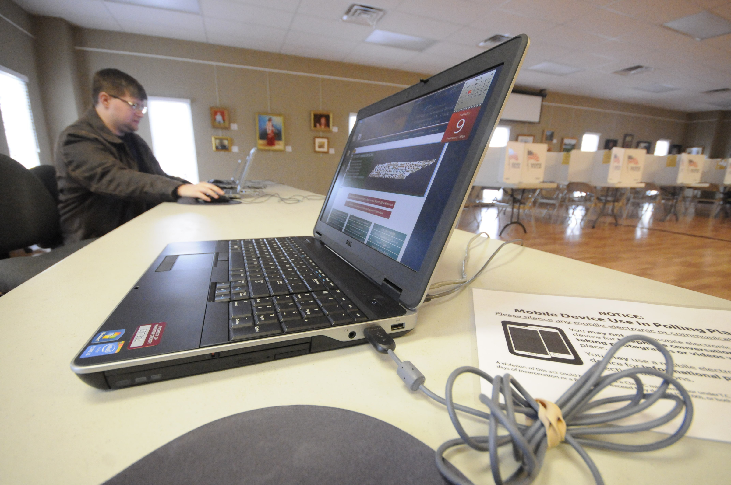 Late Tuesday afternoon, Elections Programer Nathan Foster makes sure computers and network are set up and ready for the first day of Early Voting at the North River Civic Center in Hixson.
