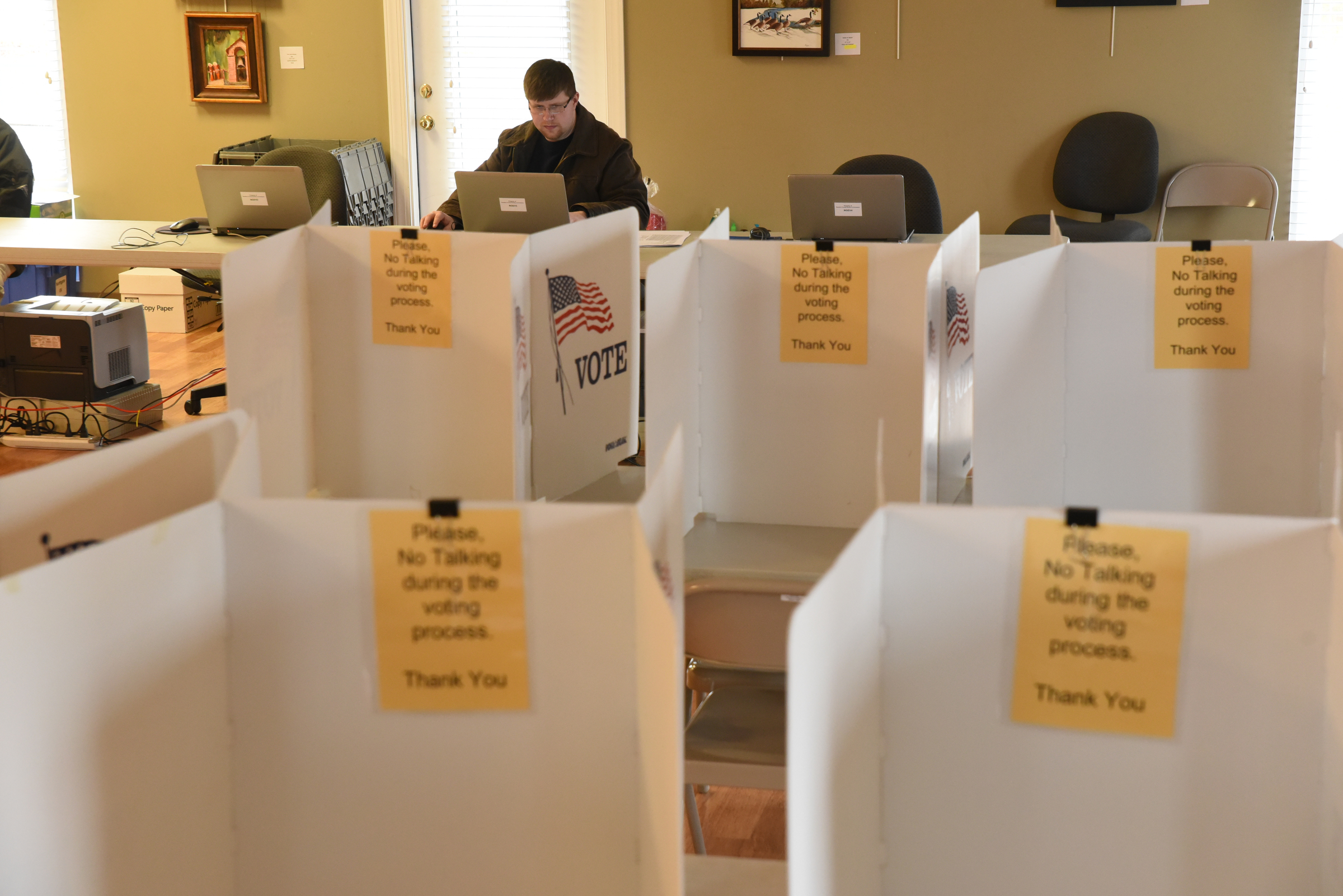 Privacy booths await early voters at the North River Civic Center in Hixson. Late Tuesday afternoon, Elections Programer Nathan Foster makes sure computers and network are set up and ready for today.