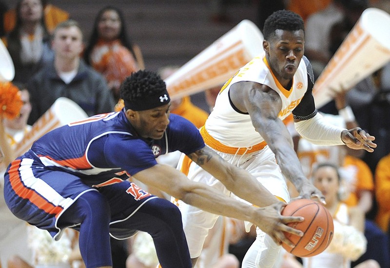 Tennessee guard Devon Baulkman (34) attempts to steal the ball from Auburn forward Horace Spencer (0) during the first half of an NCAA basketball game in Knoxville, Tenn., Tuesday, Feb. 9, 2016. Tennessee won, 71-45. (Adam Lau/Knoxville News Sentinel via AP) MANDATORY CREDIT