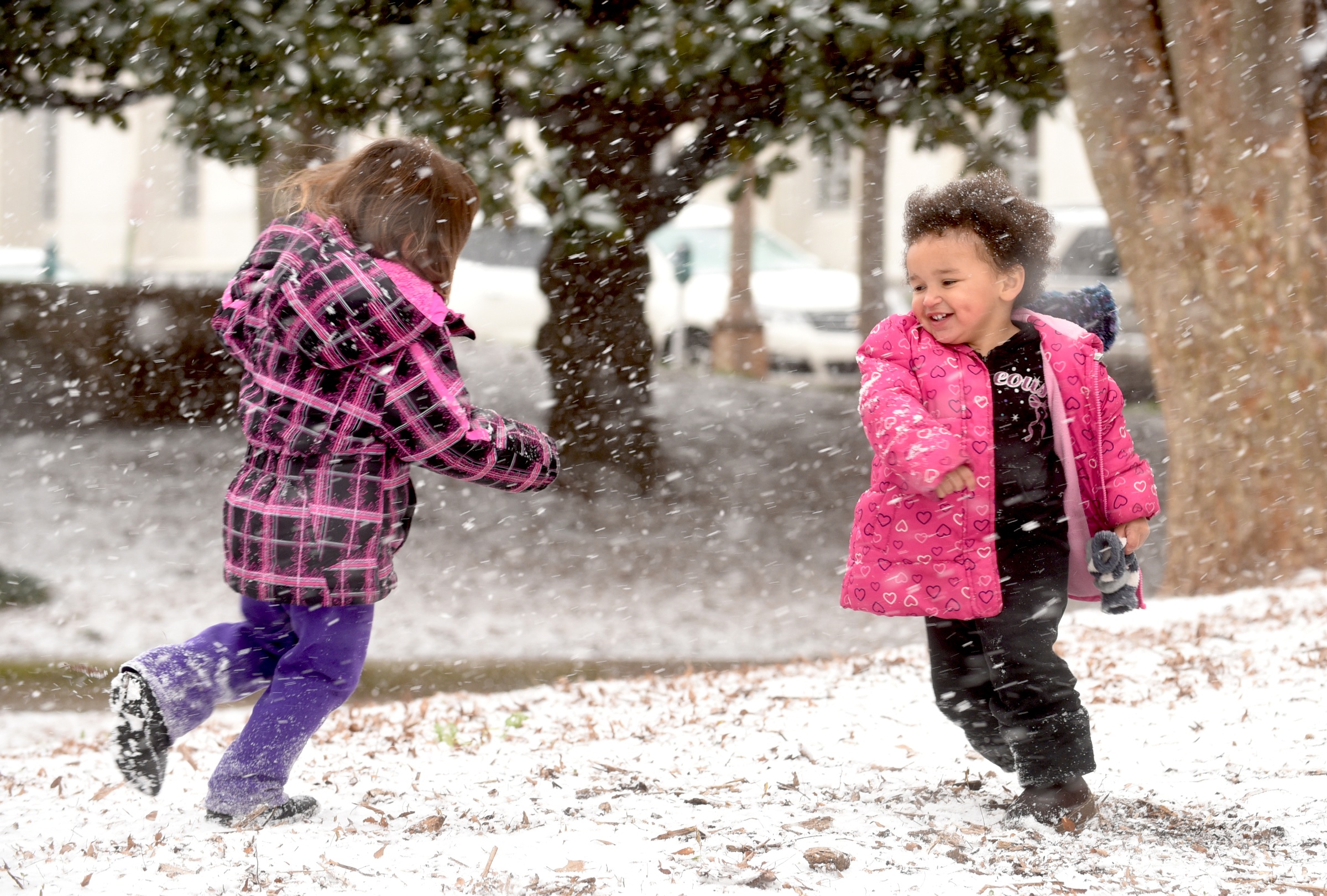 Cadence, left, and Mary Bartel play in the snow at Miller Park Tuesday, February 9, 2016.