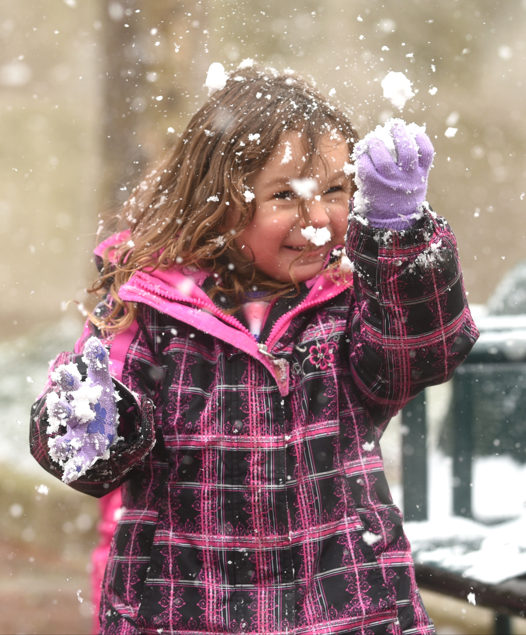 Four-year-old Cadence Bartel plays with a snowball at Miller Park Tuesday, February 9, 2016.